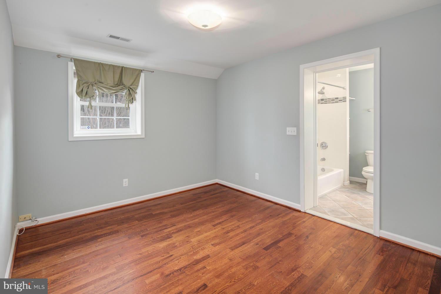 12601 Denley Road Silver Spring, MD 20906 - Photo 15 of 30 a view of an empty room with wooden floor and a window