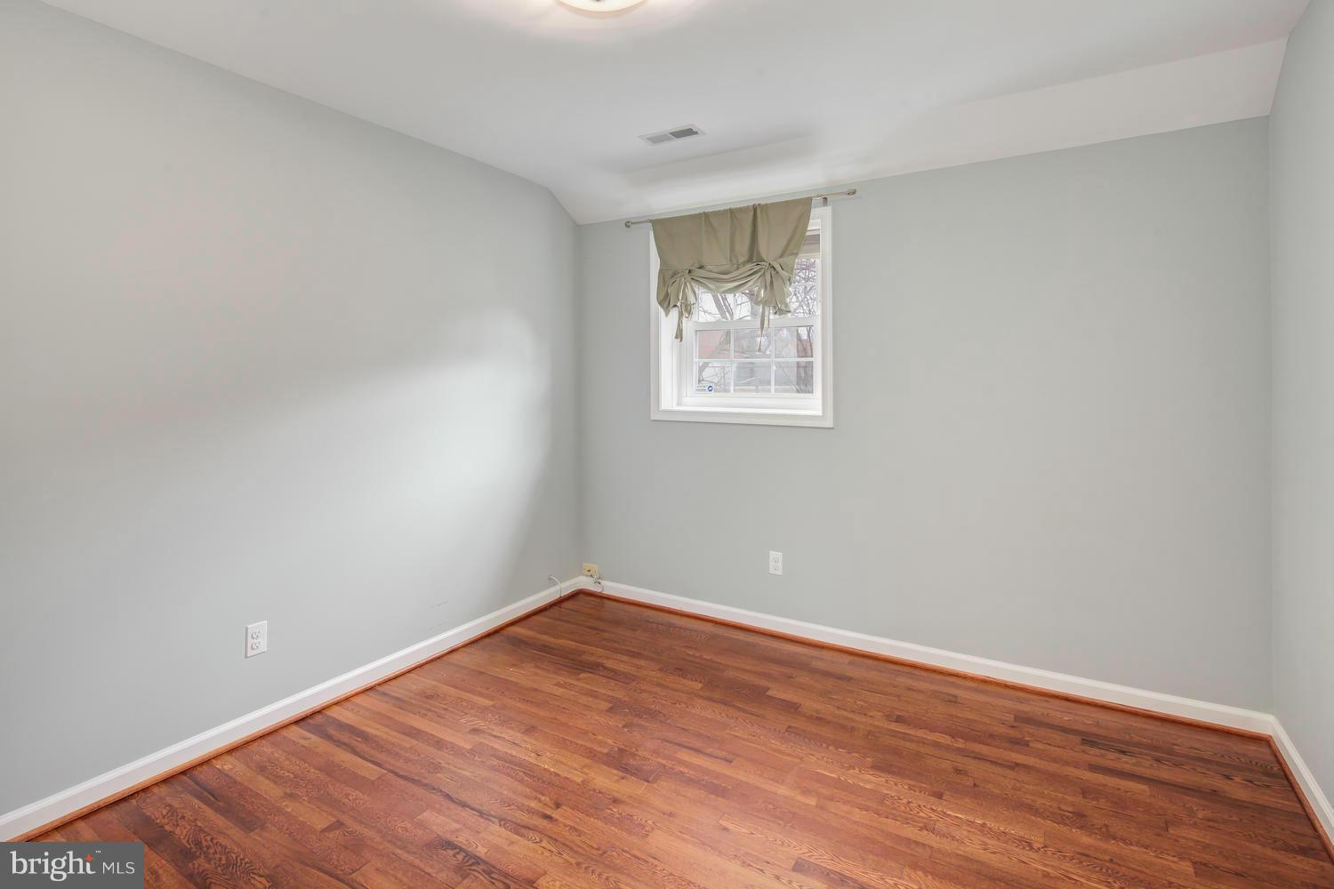 12601 Denley Road Silver Spring, MD 20906 - Photo 18 of 30 a view of an empty room with wooden floor and a window