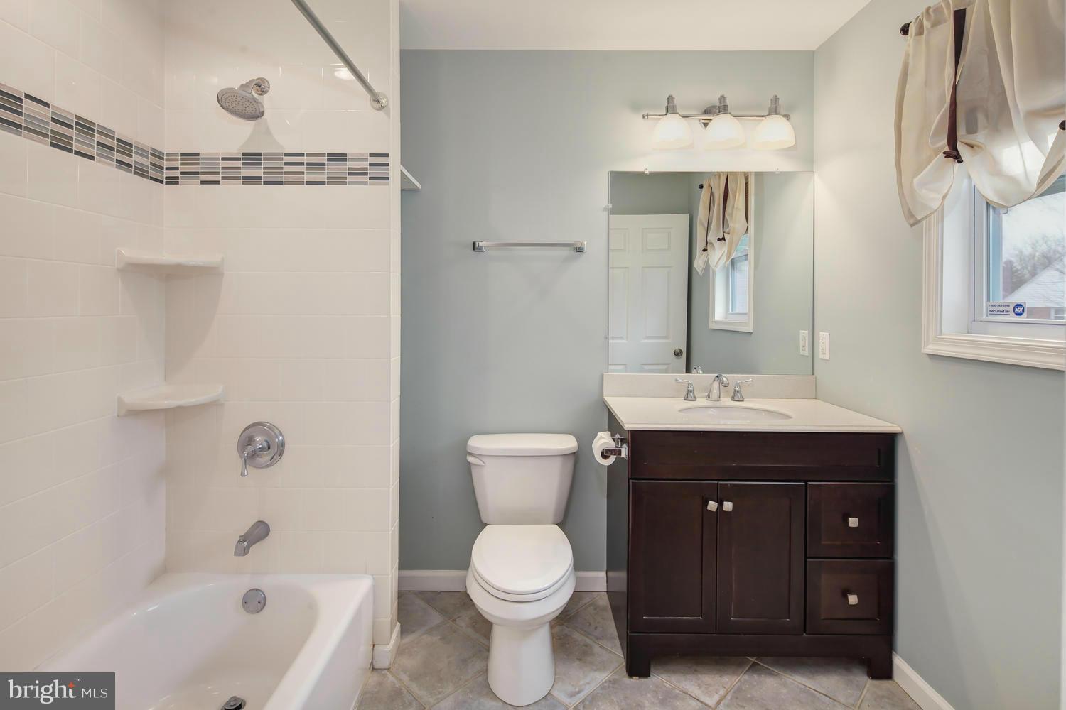 12601 Denley Road Silver Spring, MD 20906 - Photo 19 of 30 a bathroom with a sink toilet and shower