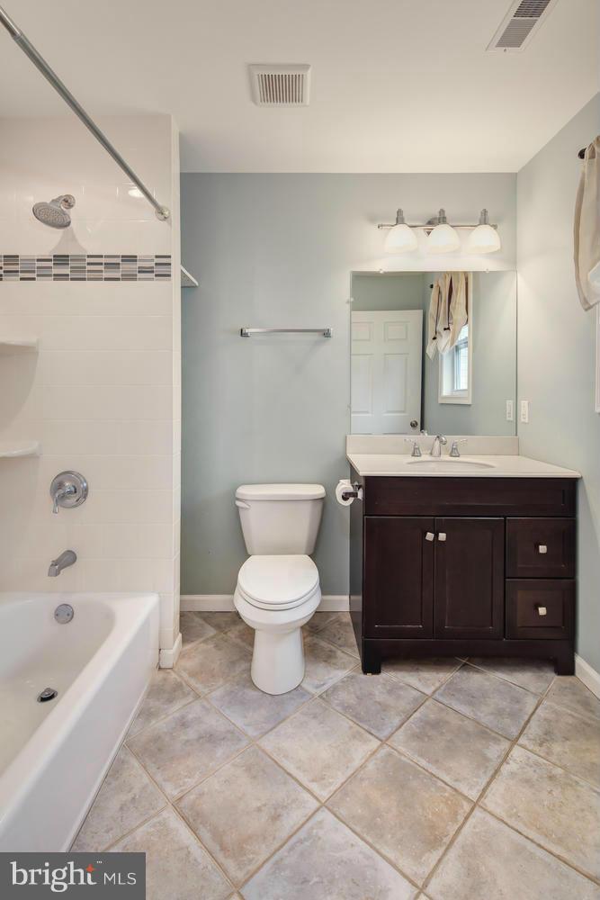 12601 Denley Road Silver Spring, MD 20906 - Photo 20 of 30 a spacious bathroom with a granite countertop toilet sink and mirror