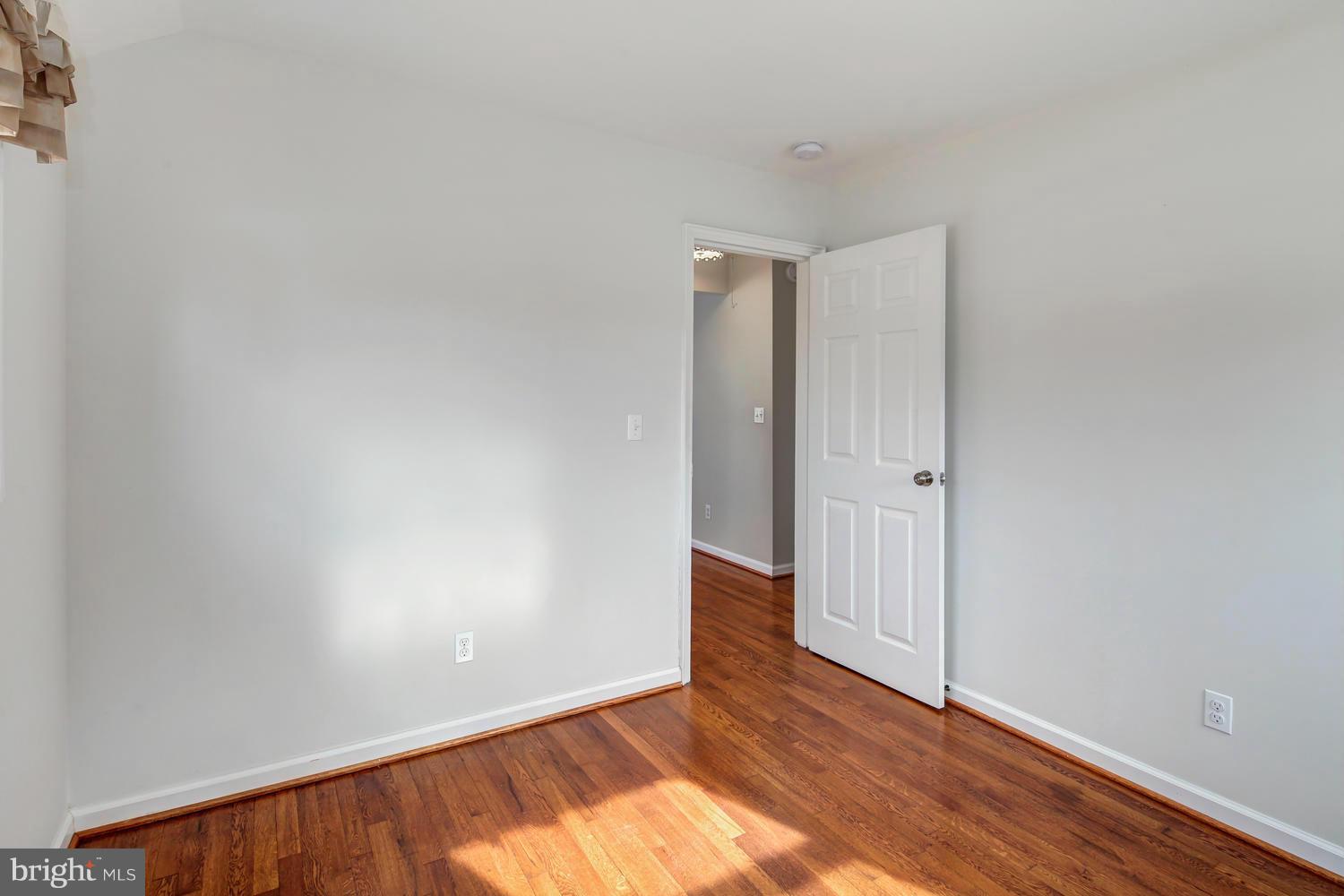 12601 Denley Road Silver Spring, MD 20906 - Photo 21 of 30 a view of an empty room with wooden floor