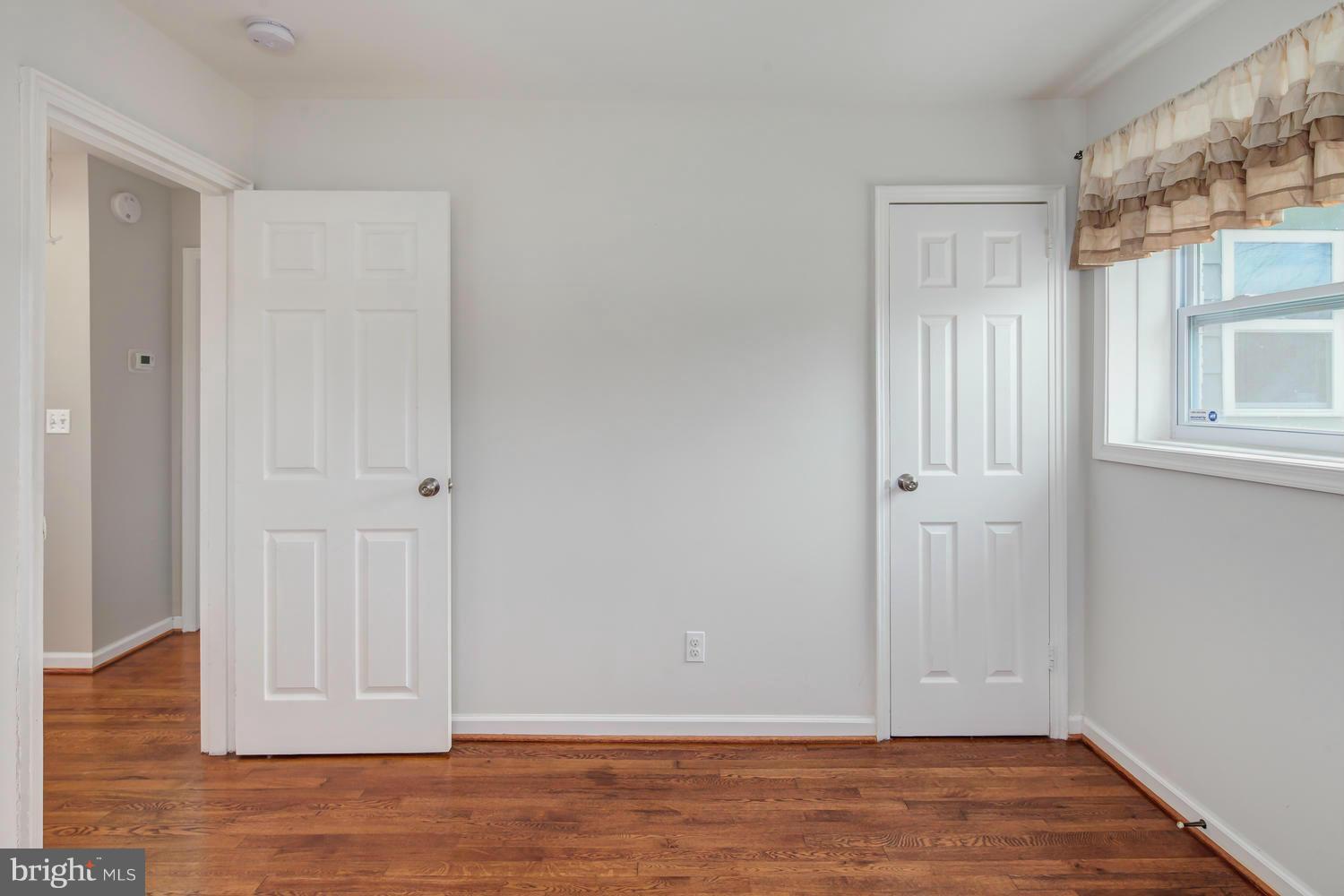 12601 Denley Road Silver Spring, MD 20906 - Photo 22 of 30 a view of an empty room with wooden floor and a window