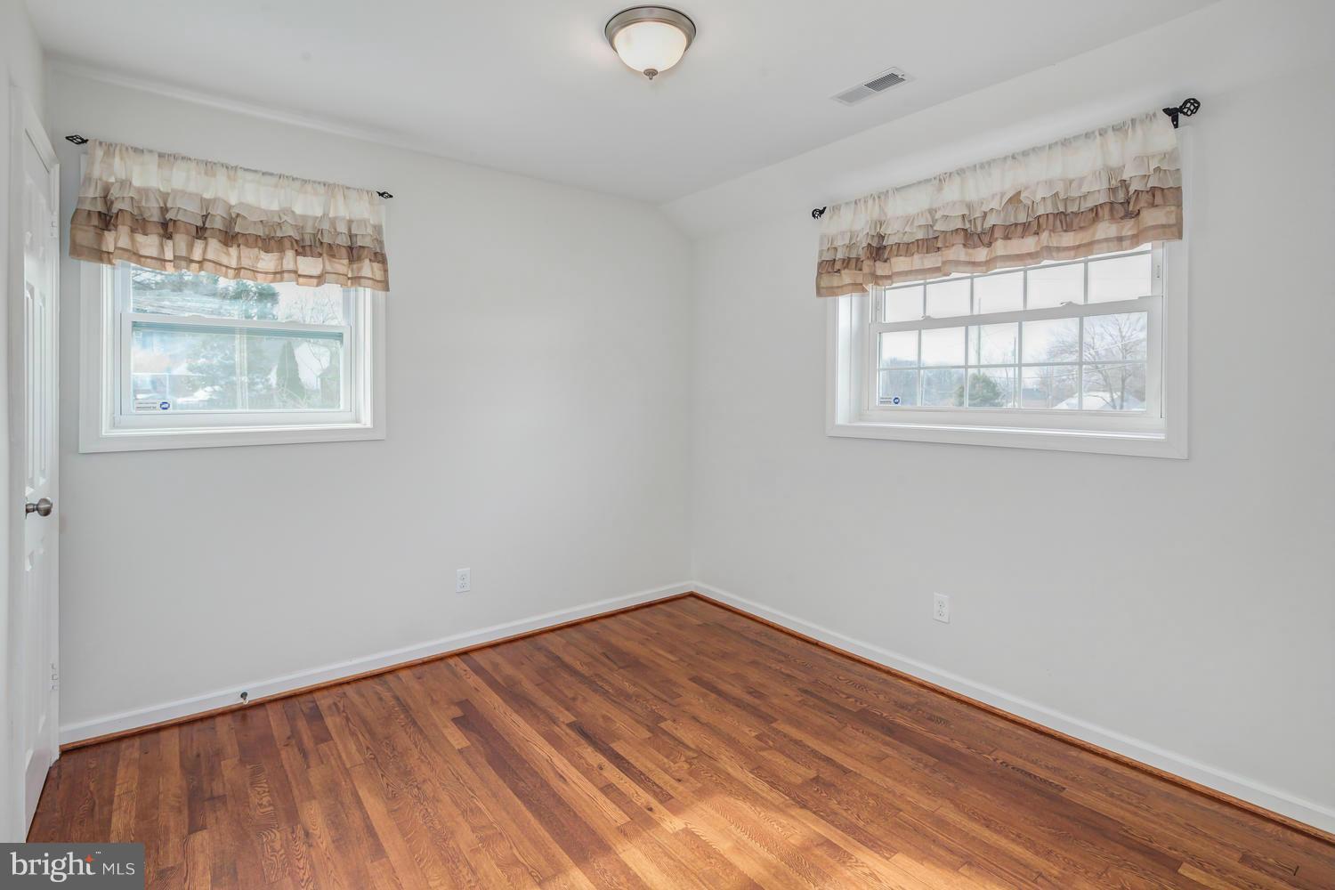 12601 Denley Road Silver Spring, MD 20906 - Photo 23 of 30 an empty room with wooden floor and windows