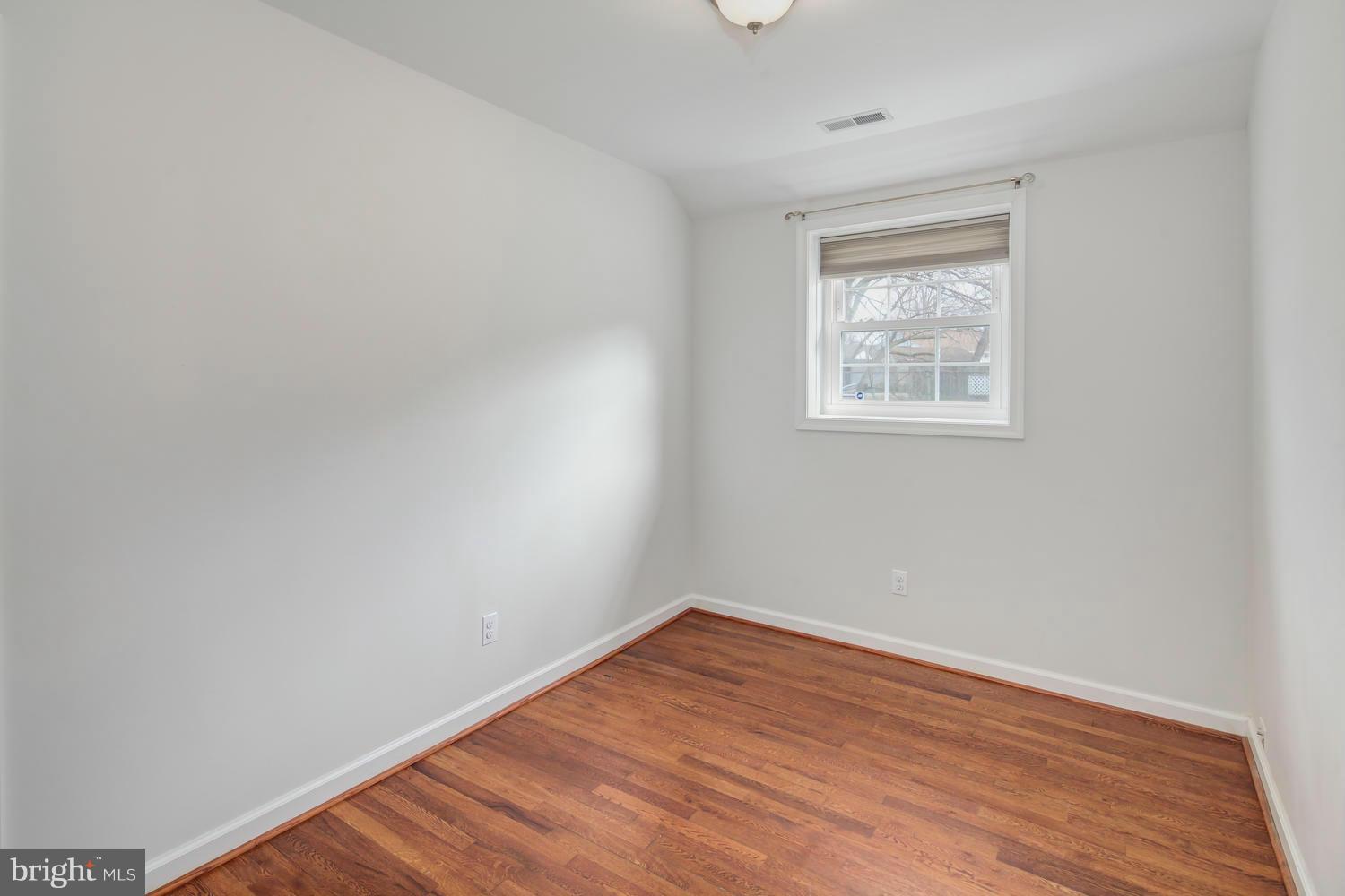12601 Denley Road Silver Spring, MD 20906 - Photo 27 of 30 an empty room with wooden floor and windows