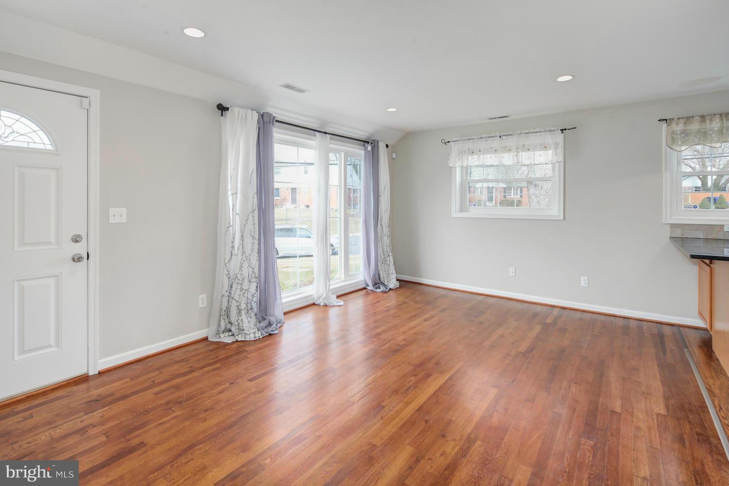 12601 Denley Road Silver Spring, MD 20906 - Photo 4 of 30 an empty room with wooden floor and windows