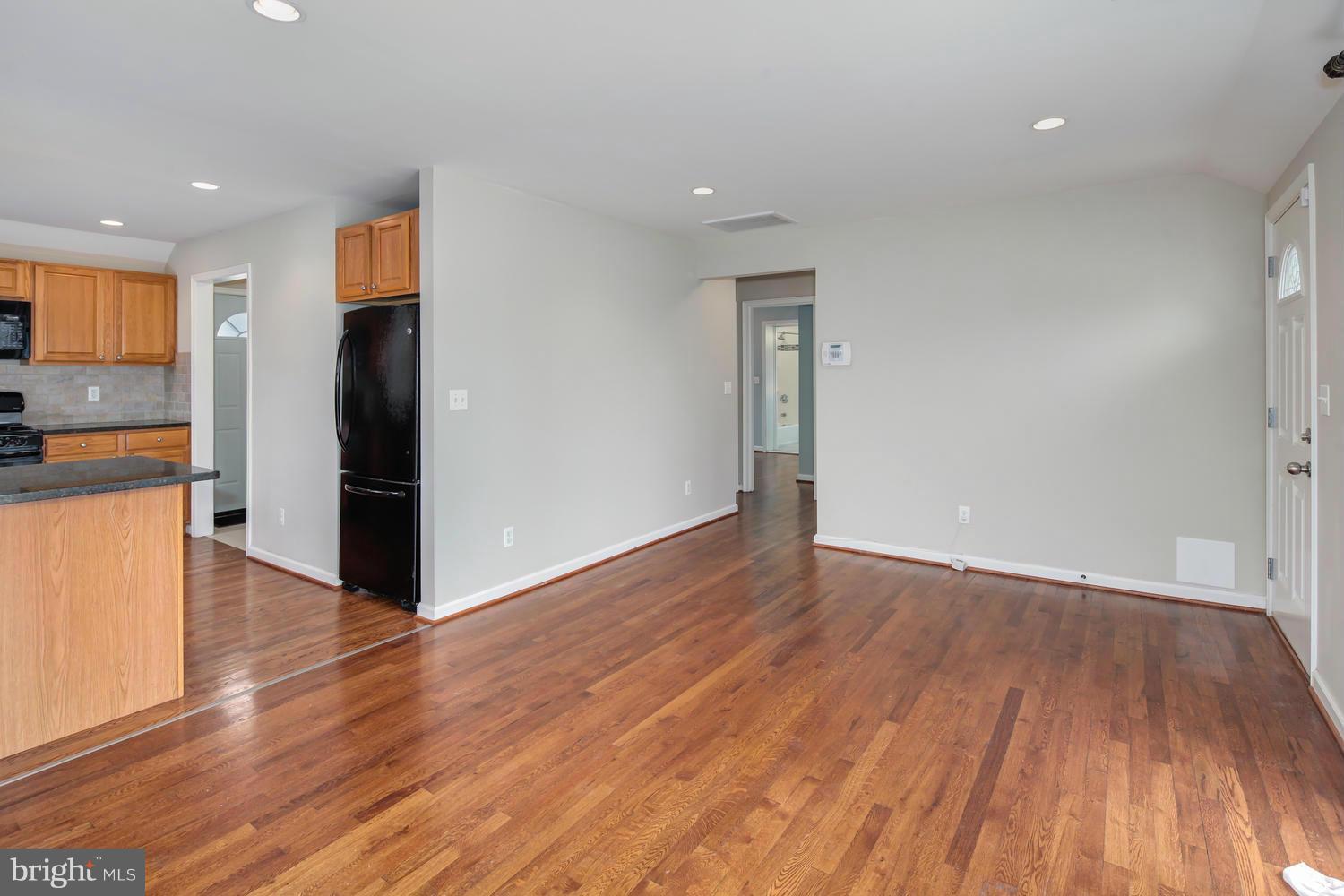 12601 Denley Road Silver Spring, MD 20906 - Photo 5 of 30 a view of a kitchen with wooden floor and a refrigerator