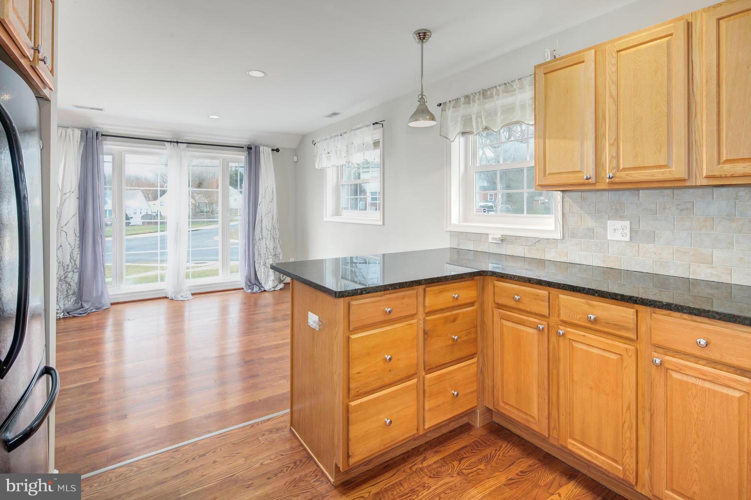 12601 Denley Road Silver Spring, MD 20906 - Photo 8 of 30 a kitchen with stainless steel appliances granite countertop cabinets and wooden floor