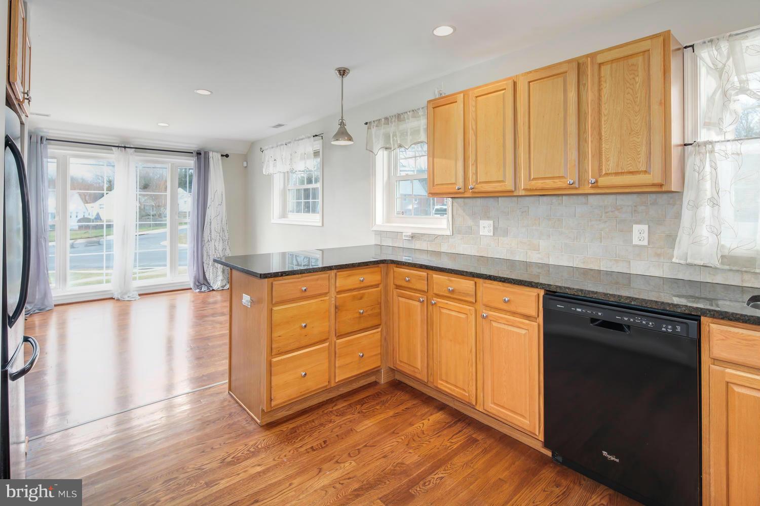 12601 Denley Road Silver Spring, MD 20906 - Photo 10 of 30 a kitchen with granite countertop cabinets stainless steel appliances and a large window