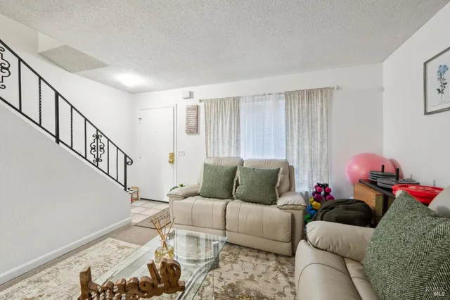 a bathroom with a sink a mirror and a potted plant