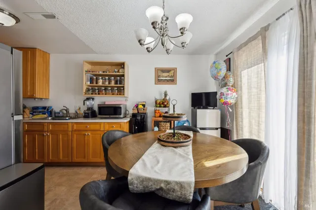 a kitchen with stainless steel appliances granite countertop a sink a stove and a refrigerator