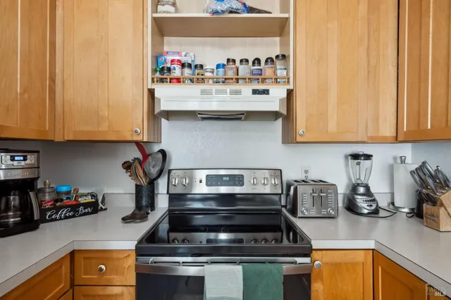 a kitchen with counter top space and dining table