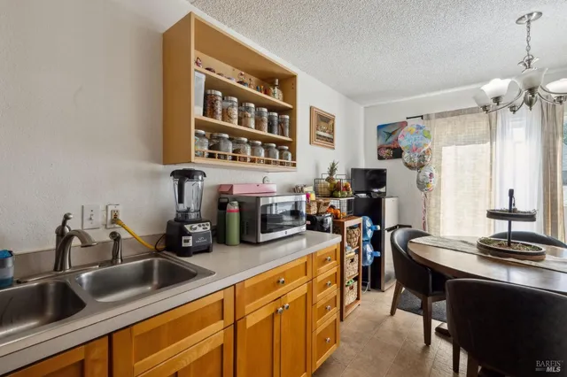 a view of a dining room with furniture and chandelier