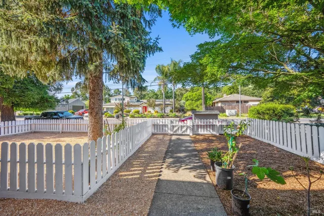 a view of a patio with table and chairs and potted plants