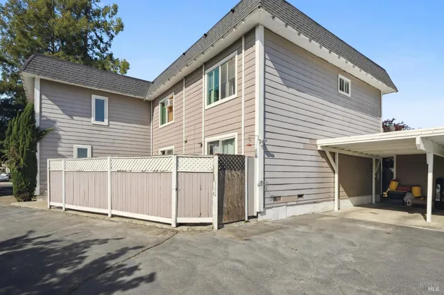 a white car parked in front of a house