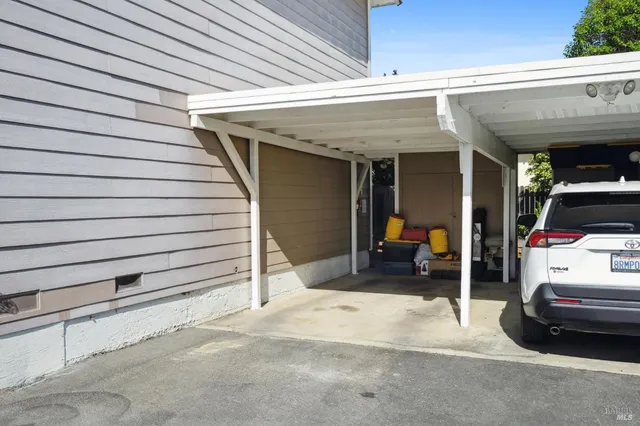 a view of a patio with table and chairs with wooden fence and plants