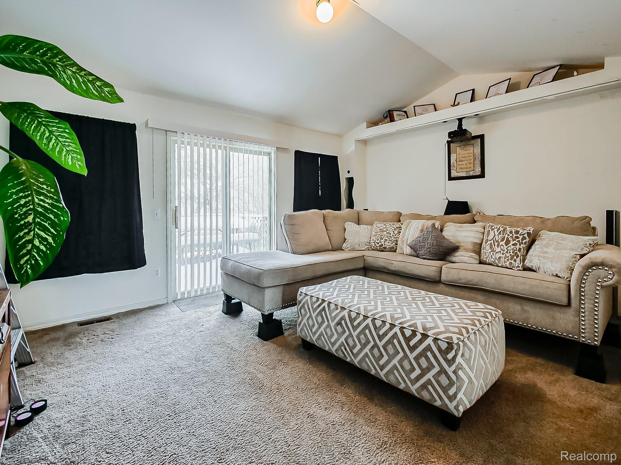 34460 Van Born Road Wayne, MI 48184 - Photo 2 of 31 Living room with carpet and lofted ceiling