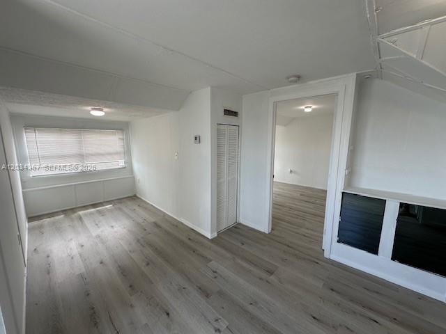 274 East 9th Street, Unit 4 Hialeah, FL 33010 - Photo 4 of 15 an empty room with wooden floor and fireplace