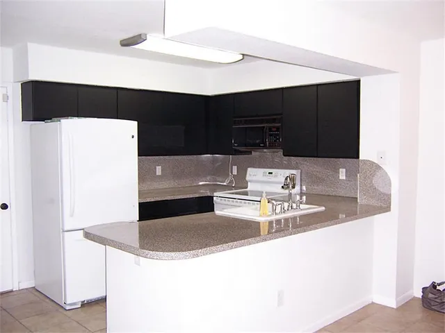 a kitchen with a sink a stove and refrigerator