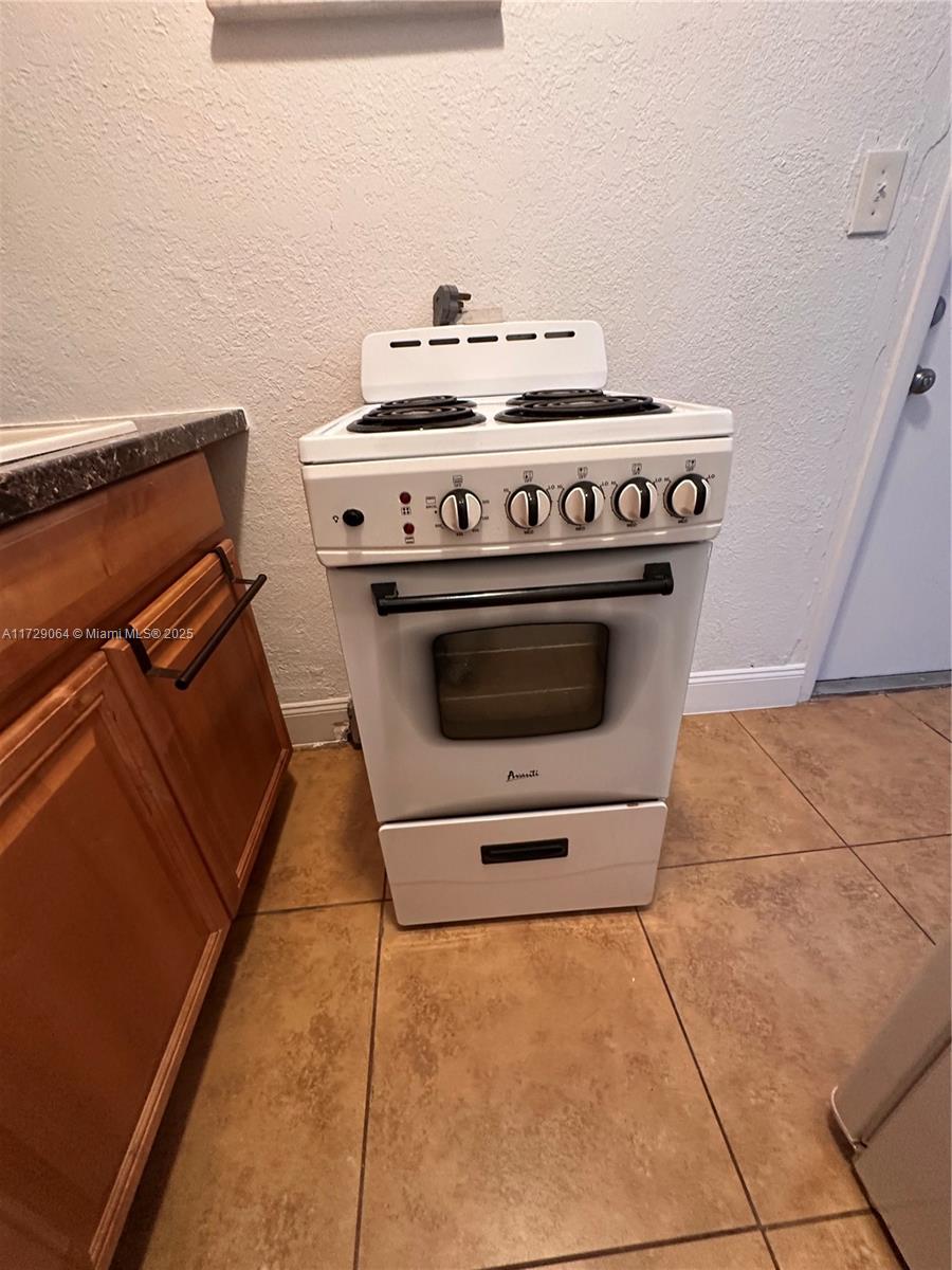 6131 Southwest 39th Street, Unit EAST Miramar, FL 33023 - Photo 15 of 15 a stove top oven sitting inside of a kitchen