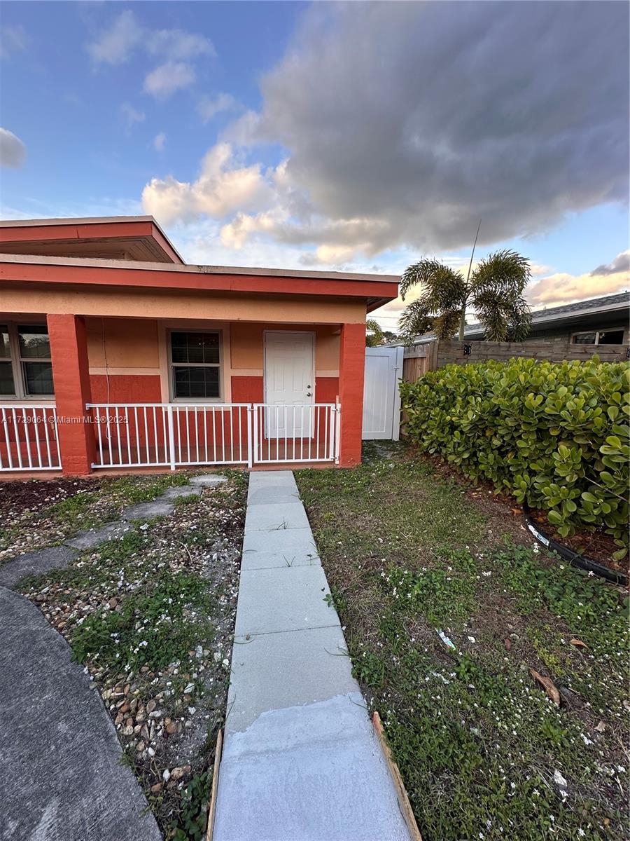 6131 Southwest 39th Street, Unit EAST Miramar, FL 33023 - Photo 2 of 15 a front view of a house with a yard