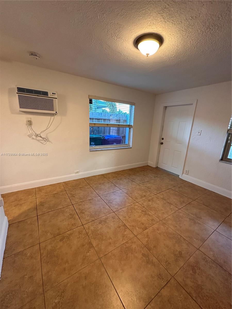 6131 Southwest 39th Street, Unit EAST Miramar, FL 33023 - Photo 5 of 15 a view of an empty room with window