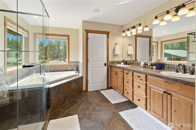 a large bathroom with double vanity and a large mirror