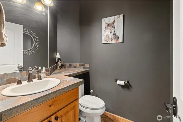 a bathroom with a toilet sink and mirror