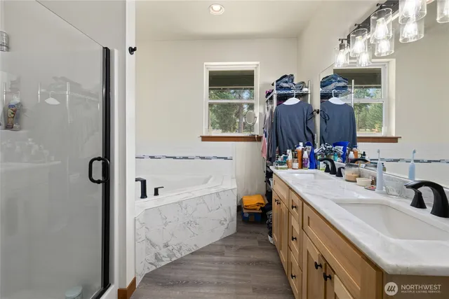 a bathroom with a tub sink and mirror