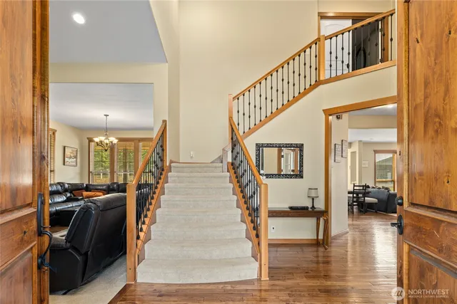 a view of entryway and hall with wooden floor