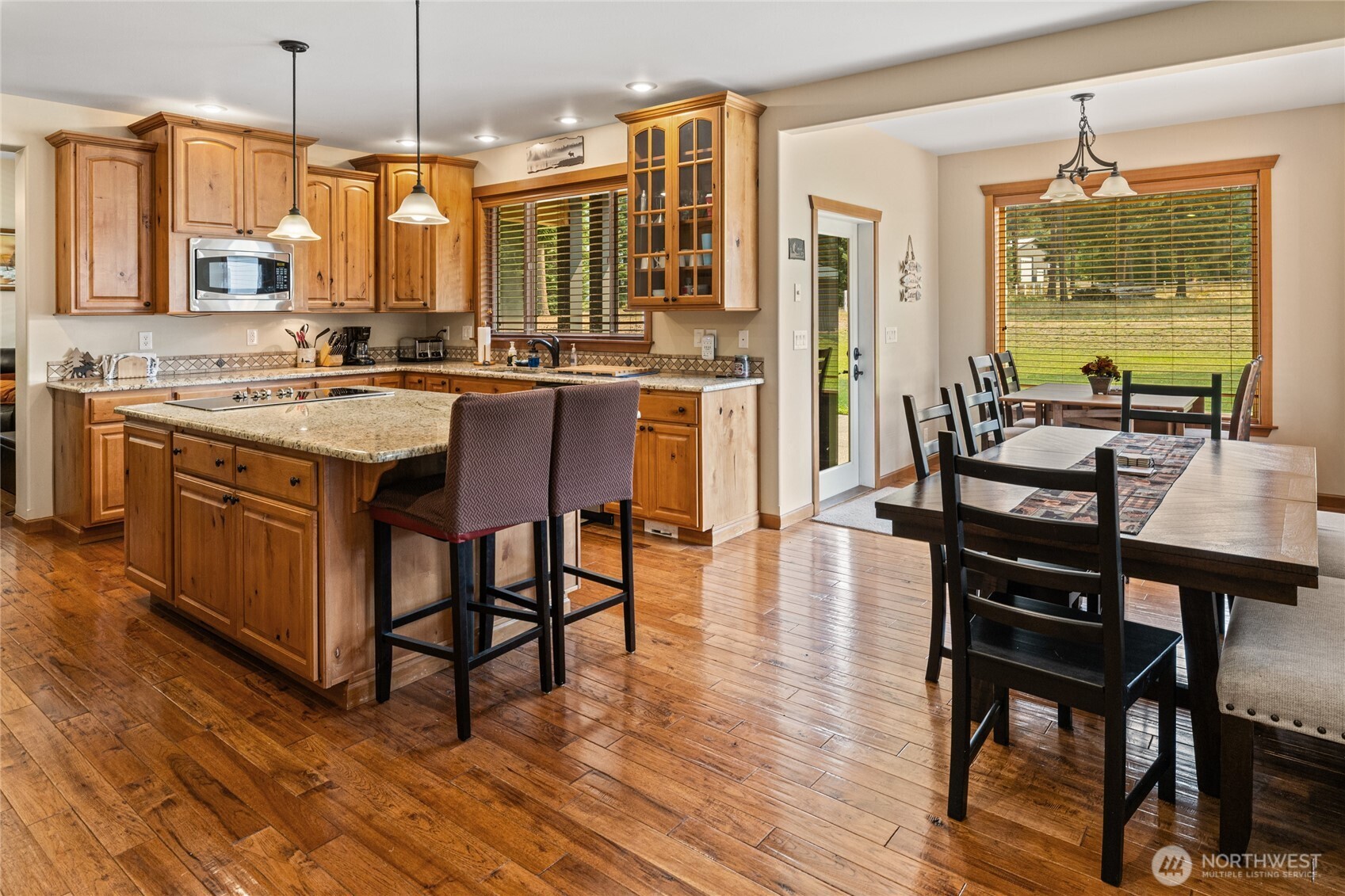 190 Revelstoke Road Cle Elum, WA 98922 - Photo 8 of 39 a kitchen with stainless steel appliances granite countertop a stove a refrigerator a kitchen island a island a stove a table and chairs