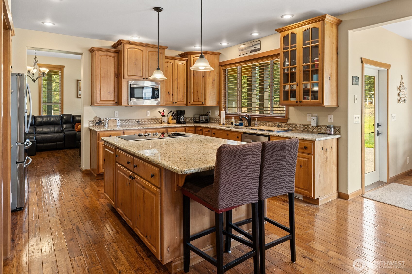 190 Revelstoke Road Cle Elum, WA 98922 - Photo 9 of 39 a kitchen with a stove a sink a refrigerator wooden floor dining table and chairs