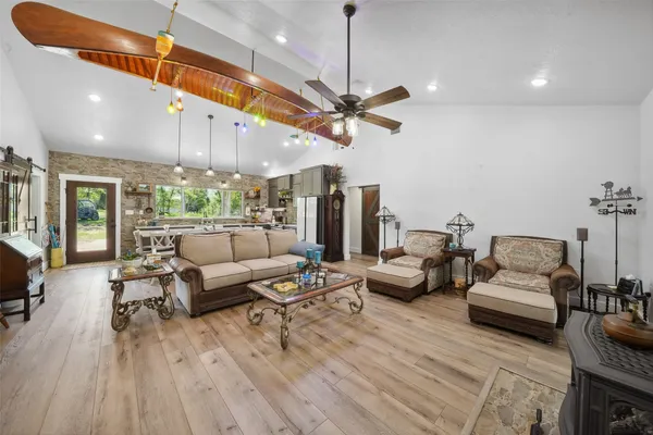 a living room with furniture a ceiling fan and a rug