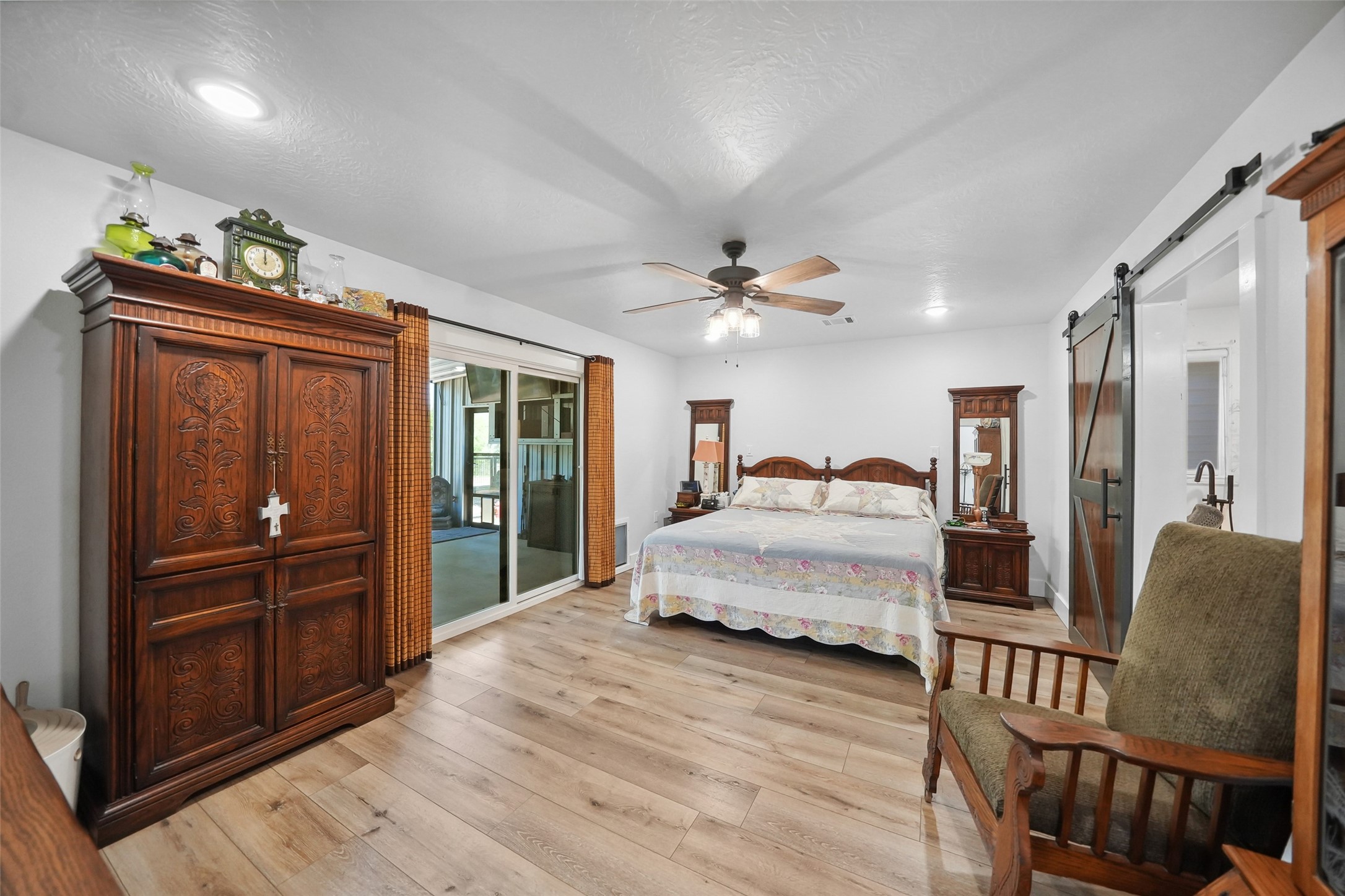 4924 County Road 4263 Marquez, TX 77865 - Photo 18 of 50 a spacious bedroom with a bed and dresser with mirror