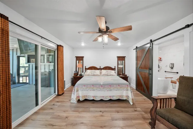 a spacious bedroom with a bed and a chandelier