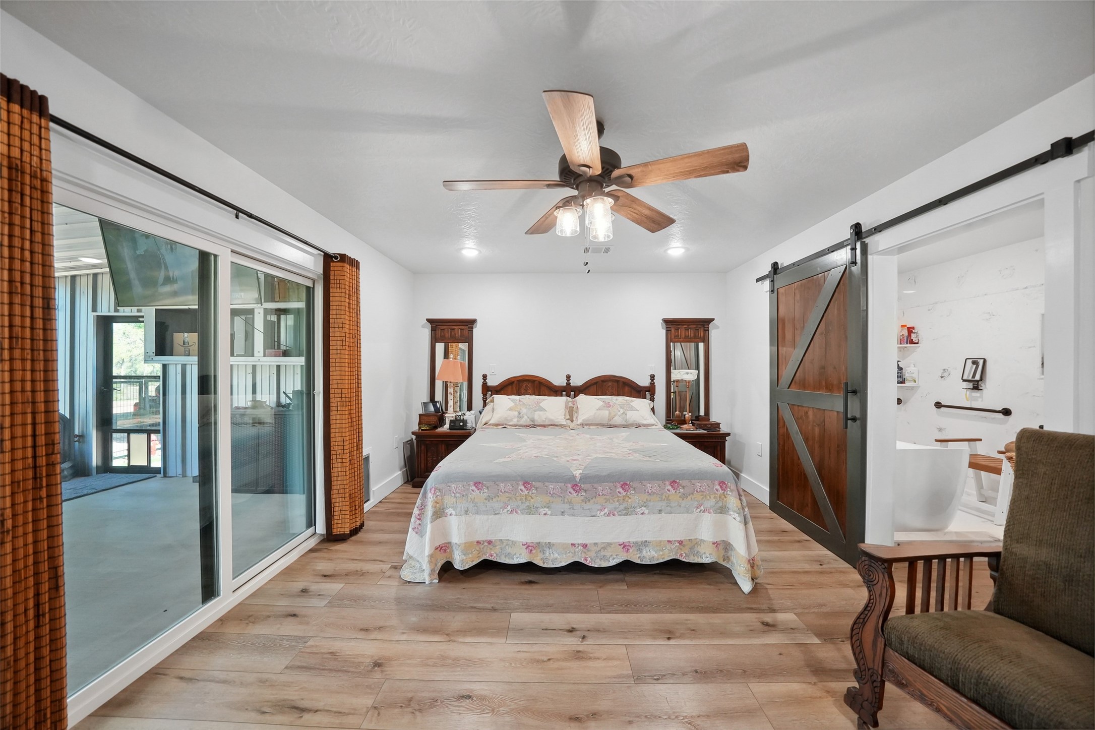 4924 County Road 4263 Marquez, TX 77865 - Photo 19 of 50 a spacious bedroom with a bed and a chandelier