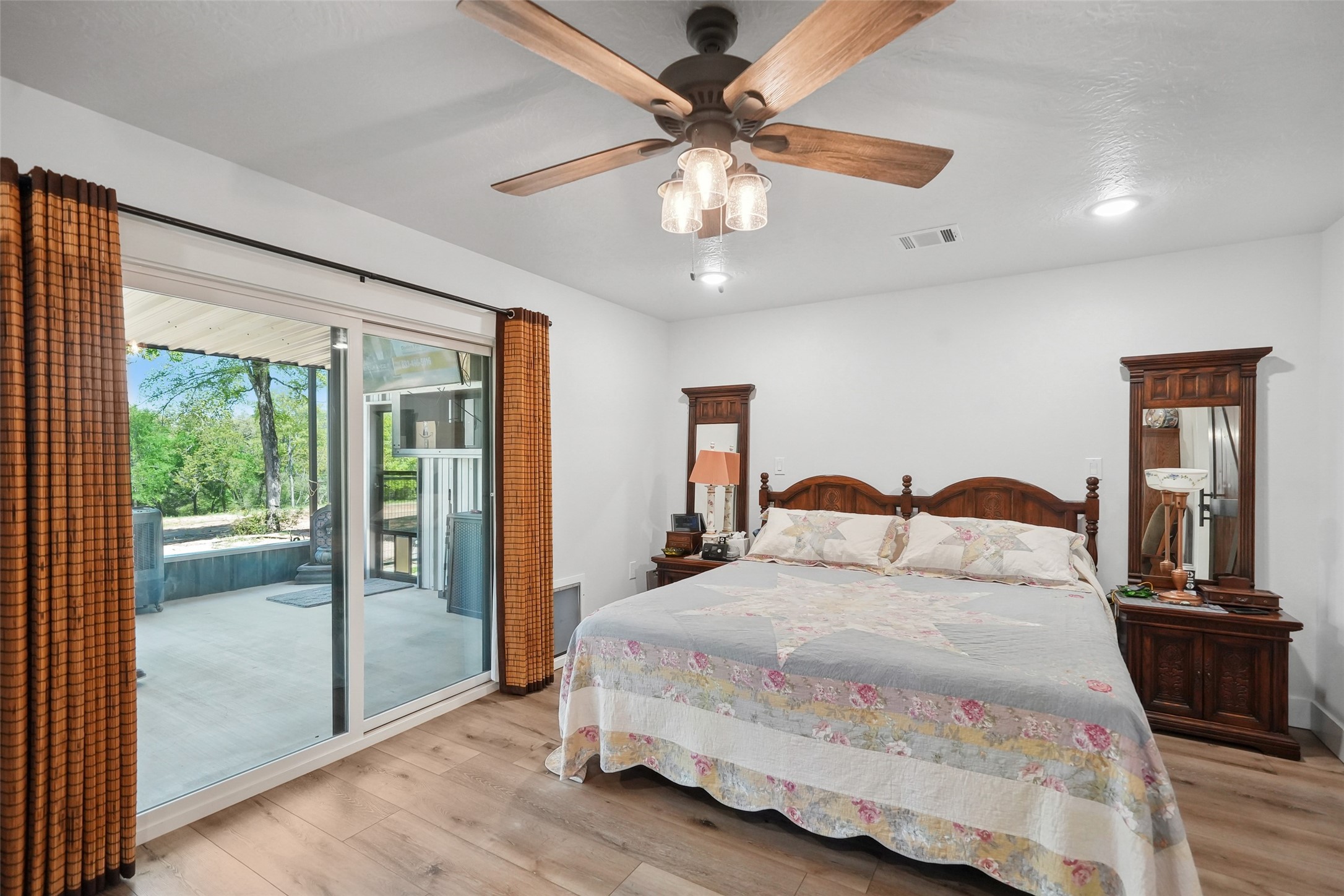 4924 County Road 4263 Marquez, TX 77865 - Photo 20 of 50 a bedroom with a large bed and a chandelier