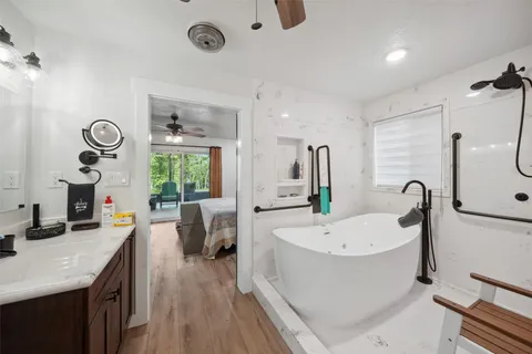 a large white kitchen with a large window