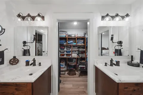 a bathroom with a sink double vanity and a mirror