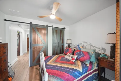 a bedroom with a bed and a chandelier