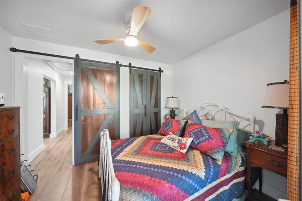 a bedroom with a bed and a chandelier