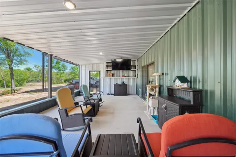 a bedroom with furniture and a large window