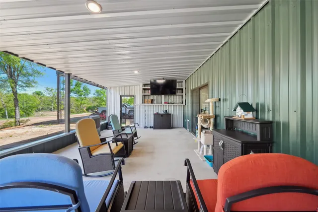 a bedroom with furniture and a large window