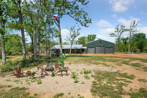 a view of swimming pool with lawn chairs and plants