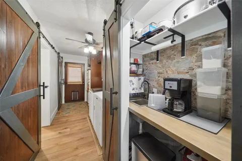 a kitchen with stainless steel appliances kitchen island granite countertop a refrigerator and a sink