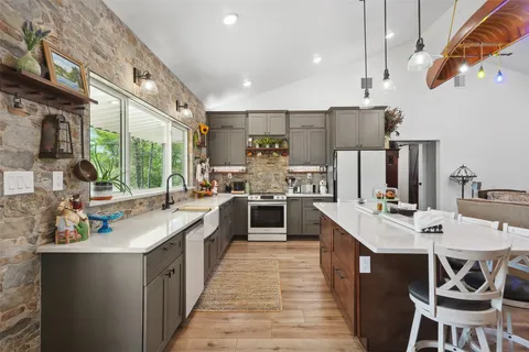 a large kitchen with a large counter top appliances and cabinets