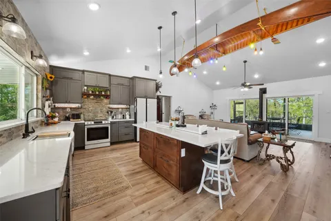 a large kitchen with a table and chairs in it
