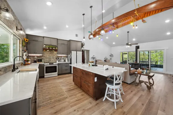 a large kitchen with a table and chairs in it