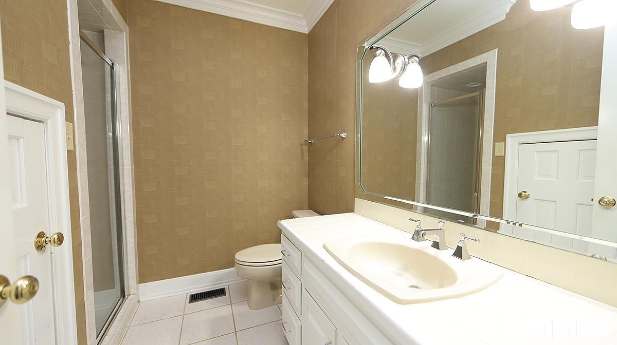 2203 Landings Way Raleigh, NC 27615 - Photo 12 of 22 a bathroom with a sink toilet and shower