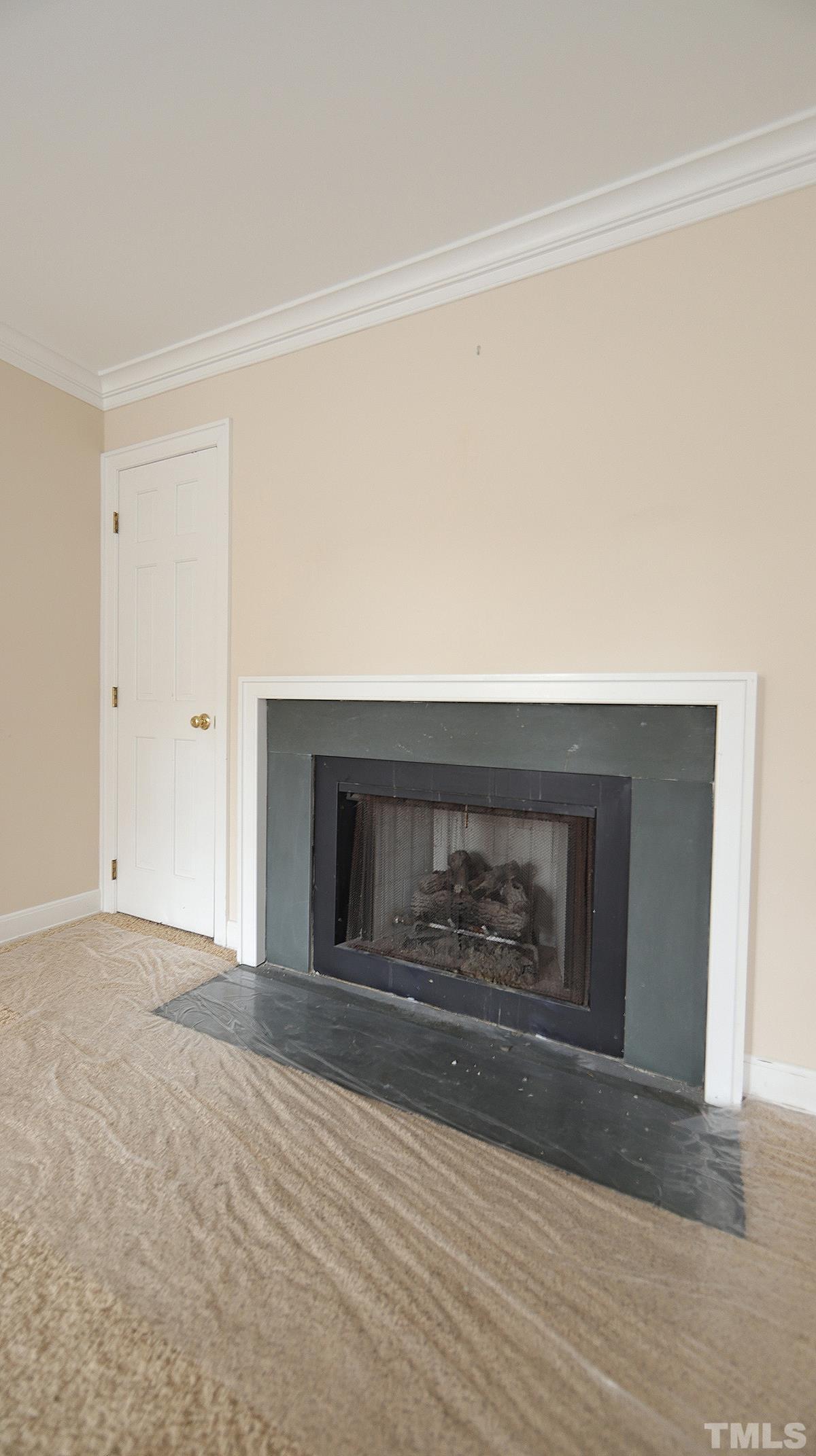 2203 Landings Way Raleigh, NC 27615 - Photo 14 of 22 a view of empty room with wooden floor and fireplace
