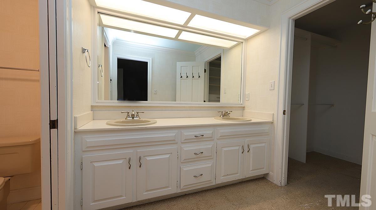 2203 Landings Way Raleigh, NC 27615 - Photo 15 of 22 a bathroom with a granite countertop sink double and mirror